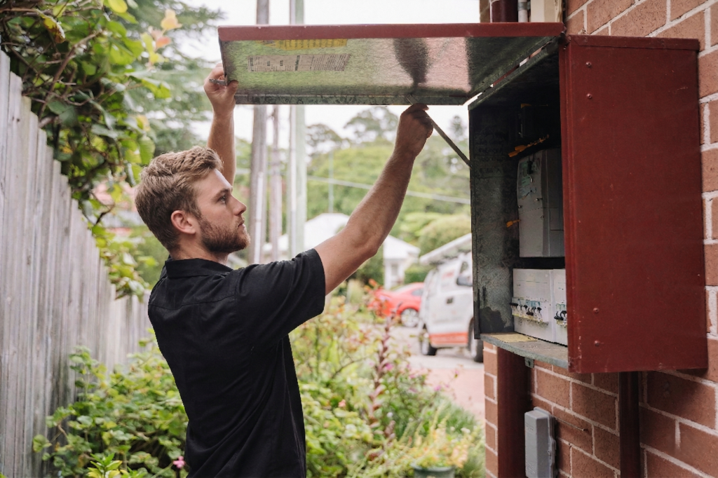 Electrician installing downlights in a Greenacre home